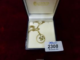 A 9ct gold chain with open frame Pendant featuring free hanging Mistletoe, in J.G. Johnstone box.