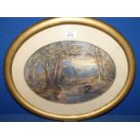 An oval framed and mounted Watercolour of a river landscape with tree lined banks and rocky