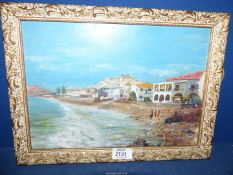 An ornately framed Oil on board of a continental seascape with houses lining the beach and figures,