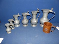 A copper RAF tankard and a set of pewter jugs.