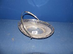 A Silver Bread Basket with pierced work decoration to the rim and swing handle, London 1906, 306.