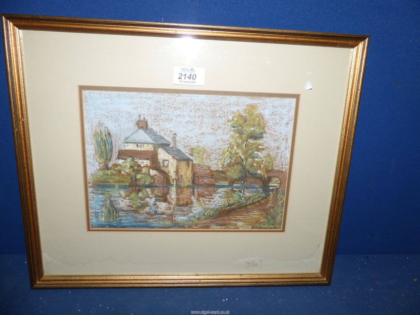 A framed and mounted Oil/Pastel of a house and river, signed lower right E.T. Jonathan, 17" x 14".