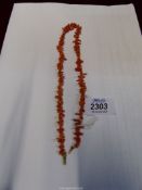 A vintage coral coloured bead necklace, 16" long.