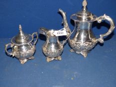 A decorative white metal three piece Teaset including teapot, milk jug, sugar bowl and lid,