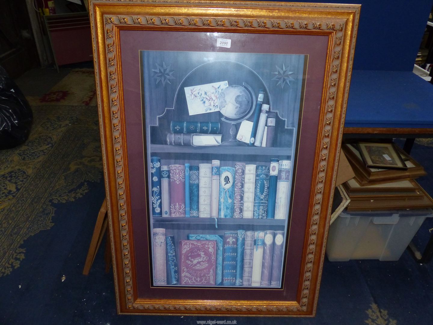 A large framed Print depicting a bookcase, 29'' x 42''.