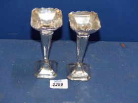 A pair of Silver Vases with weighted bases (one missing) Chester 1913, some splits,