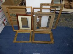A quantity of picture frames of various styles and sizes.