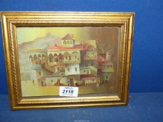 A small framed Oil on board of a continental village scene, initialled J.
