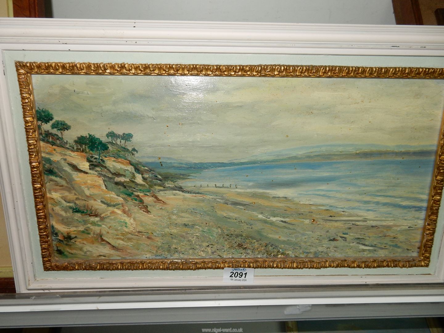 A framed Oil on board of a seascape with trees and rocky cliff to the foreground and hills in the - Image 2 of 4