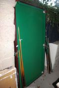 A small pool table - 38" x 72", plus rest and two cues.