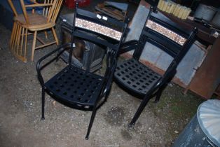Four stacking metal garden chairs.
