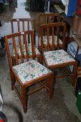 Four kitchen/dining chairs with upholstered seats.