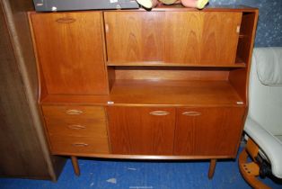 A compact Teak sideboard/cupboard - 50" high x 16" depth x 54" wide (handles a/f).