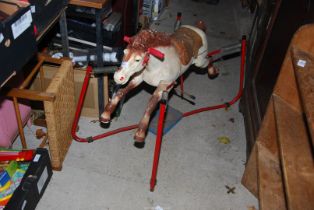 A Rocking horse on metal frame and springs.