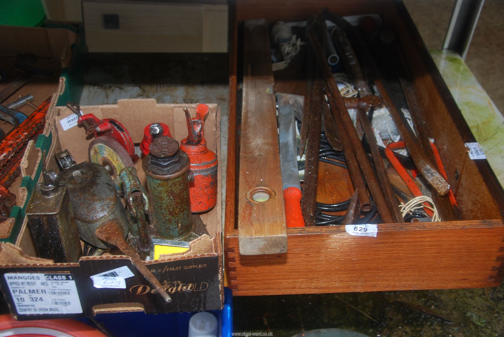 A box of miscellaneous including Oil cans, small hydraulic Jack, spirit level, etc.