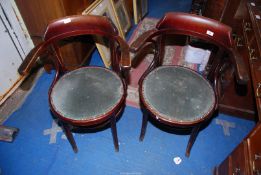 A pair of bentwood framed open armed elbow chairs with circular seats.