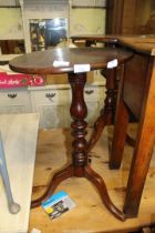 An oval Mahogany snap top occasional table on tripod base.