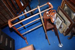 A plant stand, walking stick, shooting stick and towel rail.