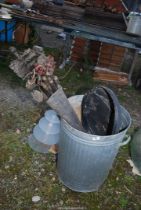 A plastic dustbin containing drainage rods.