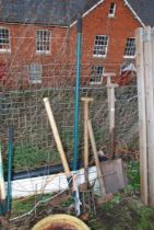 Garden equipment including: Two shovels, sledge hammer, pick axe,a fork and a long arm pruner.