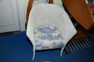 A Lloyd loom style chair.