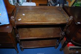 An oak three-tier dumb waiter on castors - 33" x 17½' x 39" high.