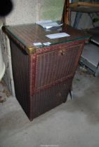 Lloyd loom style laundry basket with glass top.