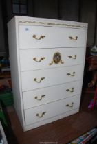 A cream coloured chest of four drawers. -2' wide x 16" depth x 3' high.