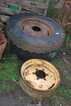 Two 600/16 'Ferguson front wheels and tyres plus one wheel centre without tyre.