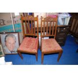 Four Oak dining chairs with art nouveau carved tops, drop-in seats.