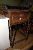 An oak sewing table with barley twist legs and a small drawer - 23" x 18½" x 31" high.
