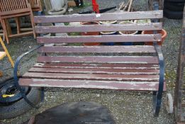 A wooden Bench with Metal scroll ends - 4' wide x 30" high x 2' depth.