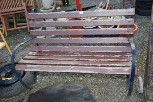 A wooden Bench with Metal scroll ends - 4' wide x 30" high x 2' depth.