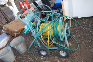A wheeled wind-up Hose Reel, and a weed Sprayer.