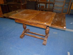 An Oak drawleaf dining table - 36" x 39" closed/ 36" x 60" open.