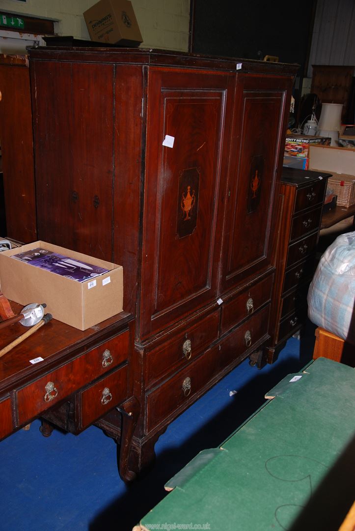 A Mahogany inlaid, cross-banded Linen Press with inlaid urn decoration to upper doors,