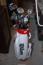 A 'Wilson' golf-bag with a quantity of golf clubs.