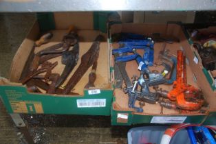 A box of brass hooks, pick axe, vice and clamp etc.