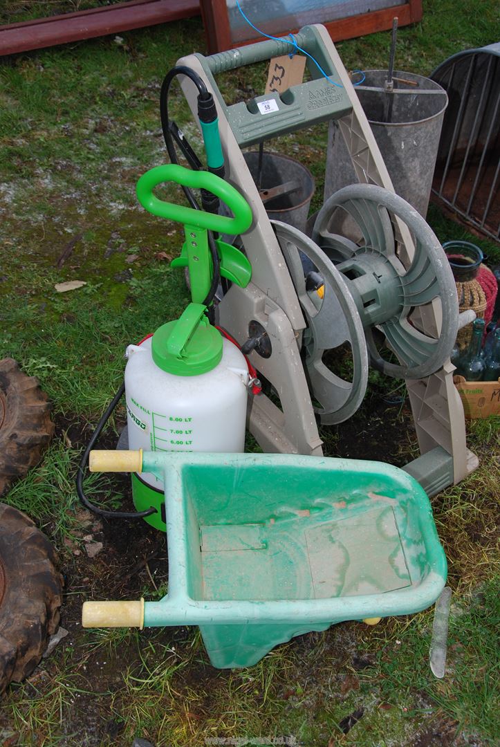 A wind-up Hose reel, Sprayer and Child's Wheelbarrow.