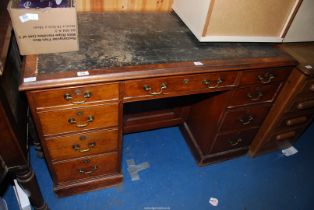 A Satinwood kneehole double pedestal desk having a leather inset type top (distressed),