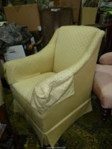 An Edwardian design Armchair of attractive angular form upholstered in pale lemon coloured fabric