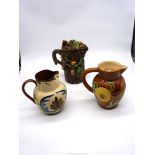 Three jugs including Watcombe Pottery motto jug,