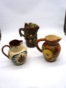 Three jugs including Watcombe Pottery motto jug,