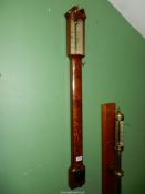 A bow fronted Mahogany cased Mercurial Stick Barometer having a swan-neck pediment,
