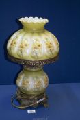 An oil Lamp converted to electric with glass reservoir and shade having floral decoration,