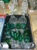 Twelve Victorian green sherry glasses and a pair of old etched decanters,