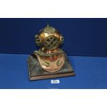 A miniature copper and brass diving helmet, 7'' x 9'' at base x 9'' tall.