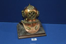 A miniature copper and brass diving helmet, 7'' x 9'' at base x 9'' tall.