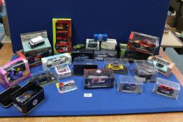 A box of Die-cast model vehicles including '007' Chevrolet Corvette, Formula 1 cars,