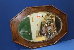 An octagonal framed bevel wall mirror, 27'' wide x 18 1/2''.